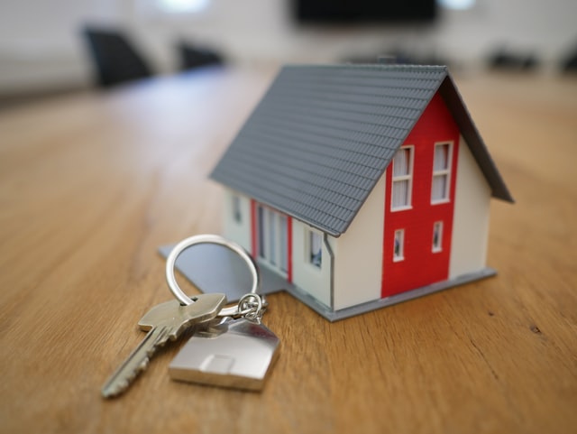 model of house with keys next to it