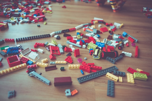 lego block pieces scattered throughout the floor of a livingroom